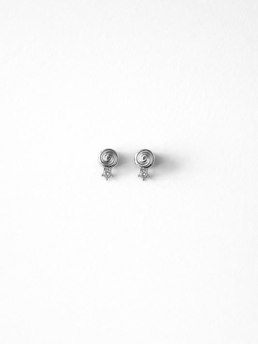 Cold Edges Alba silver spiral stud earrings with a small stone, on a white background