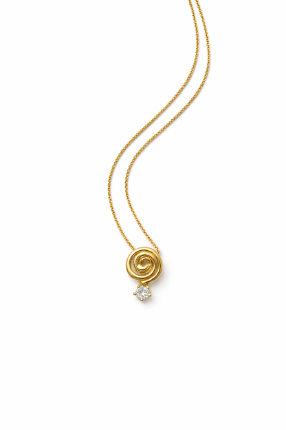 Cold Edges Alba gold spiral pendant necklace with a small stone, on a white background