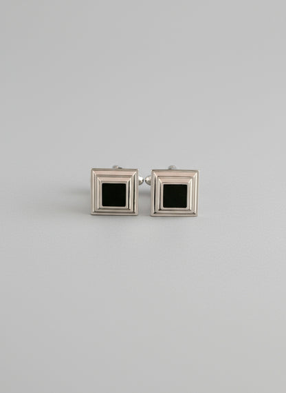 Two square frames with black centers on a white background