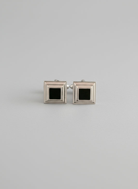 Two square frames with black centers on a white background