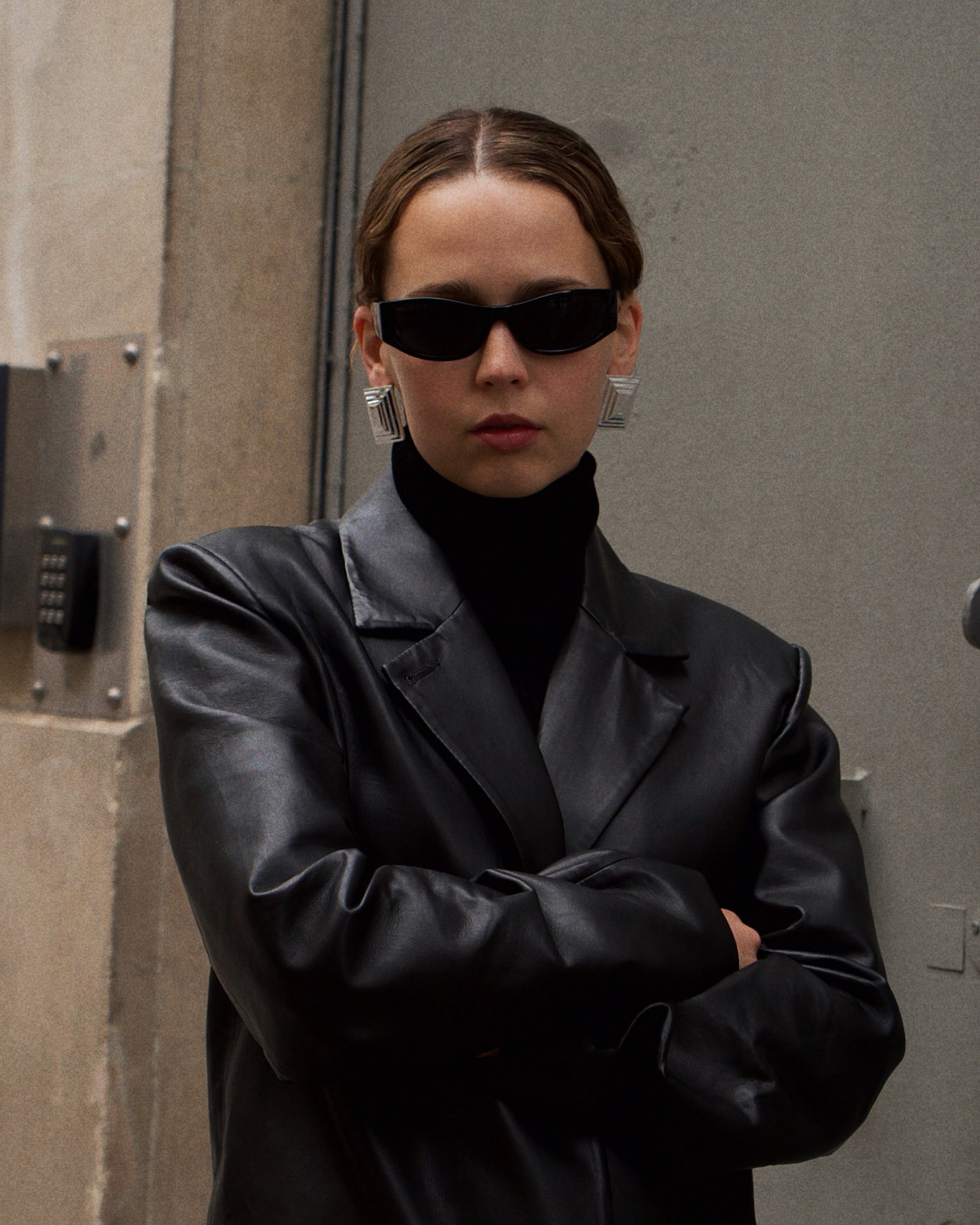 SIENTA silver earrings worn – minimalist rectangular silver earrings with a sleek, architectural silhouette.