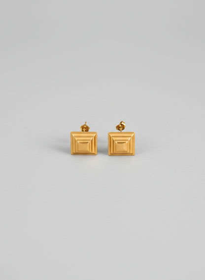 Pair of gold square earrings on a white background