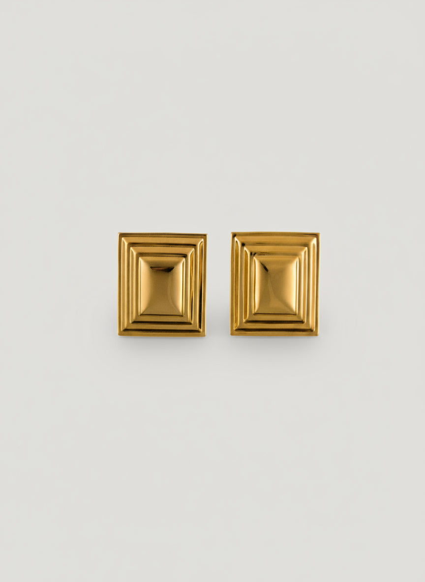 Pair of gold rectangle earrings on a white background