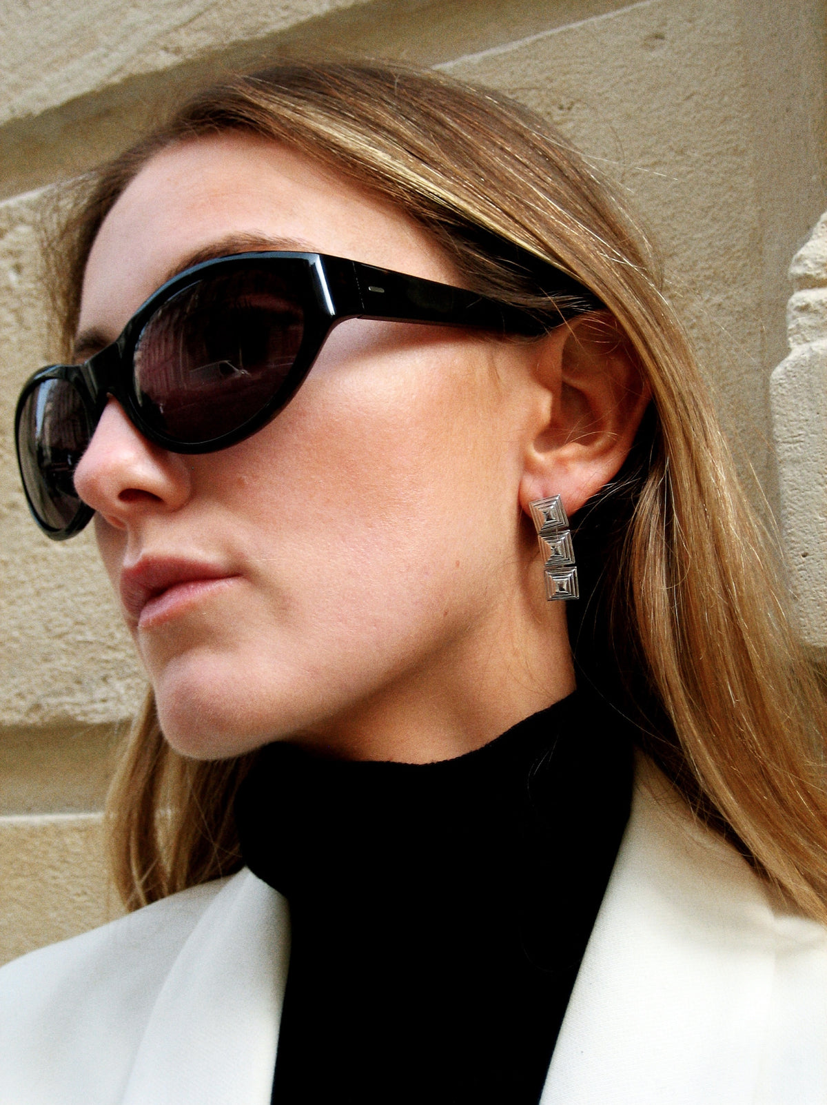 Model wearing Cold Edges Siente Stack gold stacked square drop earrings