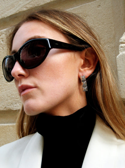 Model wearing Cold Edges Siente Stack gold stacked square drop earrings